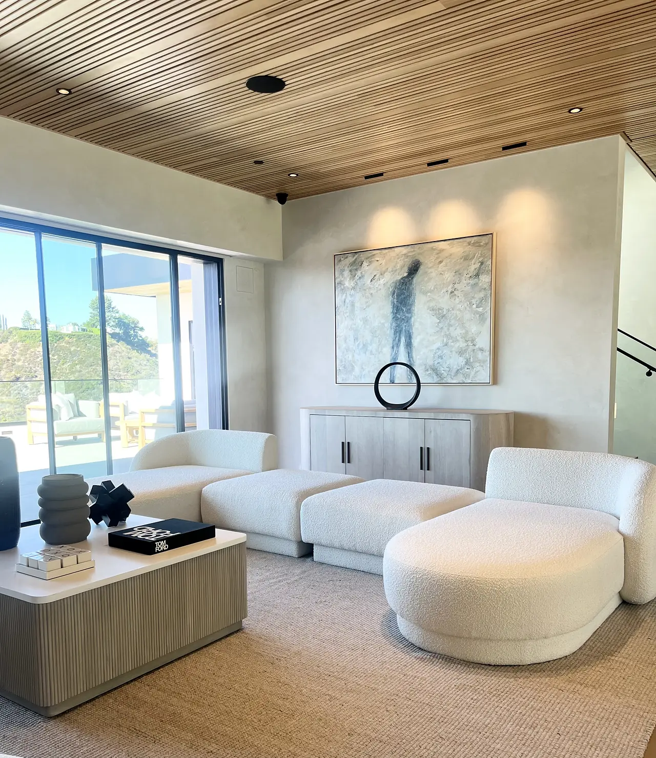 Family room with soft, matte plaster walls and a curved sectional